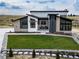 Stunning modern home featuring manicured lawn, stone accents and a unique architectural design at 8765 Canyon Wind St, Parker, CO 80138