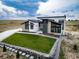Striking modern home featuring well-manicured lawn, stone accents, and contemporary design at 8765 Canyon Wind St, Parker, CO 80138