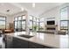 Bright, modern kitchen with a large island, breakfast bar, and views of the living area and fireplace at 8765 Canyon Wind St, Parker, CO 80138