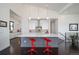 Bright kitchen with a large center island, modern lighting, and hardwood floors at 8765 Canyon Wind St, Parker, CO 80138