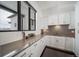 Bright kitchen featuring white cabinetry, modern countertops, and stylish finishes at 8765 Canyon Wind St, Parker, CO 80138