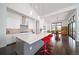 Modern kitchen with a large center island, white cabinetry and stainless steel appliances at 8765 Canyon Wind St, Parker, CO 80138