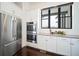 Modern kitchen with stainless steel appliances, white cabinets, and plenty of counter space at 8765 Canyon Wind St, Parker, CO 80138