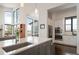 Modern kitchen featuring a large island, stainless steel appliances, and large windows with scenic views at 8765 Canyon Wind St, Parker, CO 80138