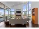 Bright living room with floor-to-ceiling windows, brick fireplace, and modern furnishings at 8765 Canyon Wind St, Parker, CO 80138