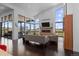 Spacious living room with floor-to-ceiling windows, modern fireplace, and hardwood floors at 8765 Canyon Wind St, Parker, CO 80138