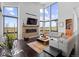 Modern living room with floor-to-ceiling windows, a brick fireplace, and comfortable seating at 8765 Canyon Wind St, Parker, CO 80138