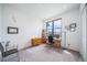 Bright home office features modern desk and shelves, and large window with neighborhood views at 8765 Canyon Wind St, Parker, CO 80138