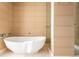 Luxurious bathroom with a stand-alone tub and elegant tan tile at 1133 14Th St # 2000, Denver, CO 80202