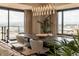 Bright dining room featuring a modern chandelier, large windows with city views, and stylish decor at 1133 14Th St # 2000, Denver, CO 80202