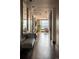 Long hallway featuring wood floors, decorative mirrors, and city views from living area at 1133 14Th St # 2000, Denver, CO 80202