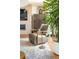 Cozy chair in living room near plant, fireplace, and wooden cabinet at 1133 14Th St # 2000, Denver, CO 80202