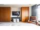 Modern bedroom features wood wardrobes, a sleek TV console, and city views at 1133 14Th St # 2000, Denver, CO 80202