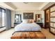 Bright bedroom with en-suite bath, large bull print, platform bed, and city views at 1133 14Th St # 2000, Denver, CO 80202