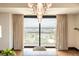 Bright room with large windows showcasing a panoramic city view and a modern lighting fixture at 1133 14Th St # 2000, Denver, CO 80202