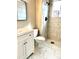 Modern bathroom featuring marble-look tile, a sleek vanity, and a walk-in shower at 7460 W Bails Ave, Lakewood, CO 80232