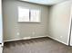 Cozy bedroom featuring carpet flooring, neutral walls, a window, and baseboard trim at 7460 W Bails Ave, Lakewood, CO 80232