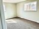 Bright bedroom featuring neutral walls, carpet flooring, and a window offering natural light at 7460 W Bails Ave, Lakewood, CO 80232