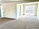 Spacious living room with carpet flooring, a sliding glass door, and a view of the backyard at 7460 W Bails Ave, Lakewood, CO 80232