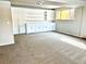 Bright living room featuring built in shelving and carpet at 7460 W Bails Ave, Lakewood, CO 80232