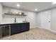 Basement bar with dark cabinets and wine cooler at 9962 W 77Th Ave, Arvada, CO 80005