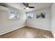 Serene bedroom featuring wood floors, abundant natural light, and minimalist decor at 9962 W 77Th Ave, Arvada, CO 80005