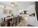 Dining area with a wood table, gray chairs and stylish decor with a view to the updated kitchen at 9962 W 77Th Ave, Arvada, CO 80005