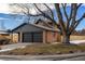 Charming brick home with a well-maintained lawn and an attached two-car garage at 9962 W 77Th Ave, Arvada, CO 80005