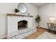 White brick fireplace with a herringbone tiled hearth at 9962 W 77Th Ave, Arvada, CO 80005