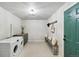 Laundry room with bench, shelves and green door at 9962 W 77Th Ave, Arvada, CO 80005