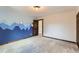 Bedroom with a mountain themed accent wall and natural wood trim at 7219 S Brook Forest Rd, Evergreen, CO 80439