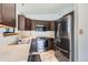 Functional kitchen with stainless steel appliances and dark wood cabinets at 7219 S Brook Forest Rd, Evergreen, CO 80439