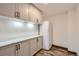 Kitchenette with gray cabinets, white countertops, and a white refrigerator, offering a practical space at 7219 S Brook Forest Rd, Evergreen, CO 80439