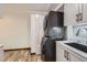 Laundry room with stackable washer/dryer, white cabinets, and marble countertop, maximizing space and functionality at 7219 S Brook Forest Rd, Evergreen, CO 80439