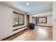 Spacious living room with wood flooring, large windows with views, and a brick fireplace with a stove at 7219 S Brook Forest Rd, Evergreen, CO 80439