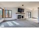 Open living room featuring a stone fireplace and sliding door access to the outdoors at 7219 S Brook Forest Rd, Evergreen, CO 80439