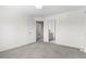 Empty bedroom with carpet and open doorway to hall and bathroom at 9284 S Cedar Hill Way, Lone Tree, CO 80124