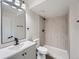 Basement bathroom with wood-look tile shower and gray vanity at 1435 S Victor St, Aurora, CO 80012