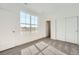 Bright bedroom featuring a large window, plush carpet, and closet space at 2150 S Haleyville Way, Aurora, CO 80018