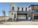 Charming two-story home with a two-car garage, stone accents, and covered front porch at 2150 S Haleyville Way, Aurora, CO 80018