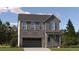 Charming two-story home with stone accents and a covered front porch, surrounded by lush trees and greenery at 2150 S Haleyville Way, Aurora, CO 80018
