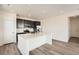 Well-lit kitchen with stainless steel appliances, quartz countertops, and a center island at 2150 S Haleyville Way, Aurora, CO 80018