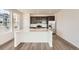 Modern kitchen features a large island, stainless steel appliances, and dark cabinetry at 2150 S Haleyville Way, Aurora, CO 80018