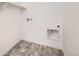 Bright laundry room features modern tile flooring, a white shelf, and white walls at 2150 S Haleyville Way, Aurora, CO 80018