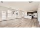 Bright, open-concept area with large windows, hardwood floors, and a view into the kitchen at 2150 S Haleyville Way, Aurora, CO 80018