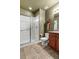Well-lit bathroom featuring a glass-enclosed shower, wooden vanity, and stylish fixtures for a comfortable space at 6618 Lynch Ln, Castle Rock, CO 80108