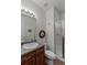 Bright bathroom with a shower, wood vanity, and neutral fixtures, creating a clean and functional space at 6618 Lynch Ln, Castle Rock, CO 80108