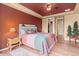 Cozy bedroom showcasing wood floors, a stylish ceiling fan, and inviting decor, creating a warm and relaxing atmosphere at 6618 Lynch Ln, Castle Rock, CO 80108