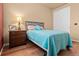 Comfortable bedroom with hardwood floors, neutral walls, and a sliding door closet at 6618 Lynch Ln, Castle Rock, CO 80108