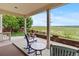 Comfortable covered patio with seating area overlooking a vast field, perfect for relaxing and enjoying the outdoors at 6618 Lynch Ln, Castle Rock, CO 80108